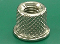 Press fitting of a metal nut is desired to be accomplished in a short period of time